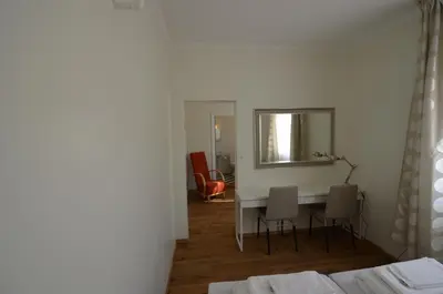 a room with a table and chairs and a mirror at Fossli Hotel in Eidfjord