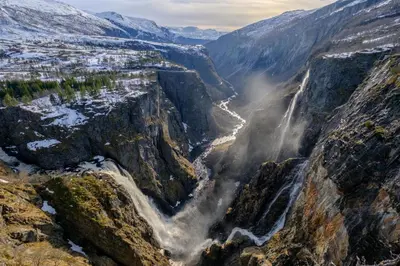 a waterfall on the side of a mountain at Fossli Hotel in Eidfjord