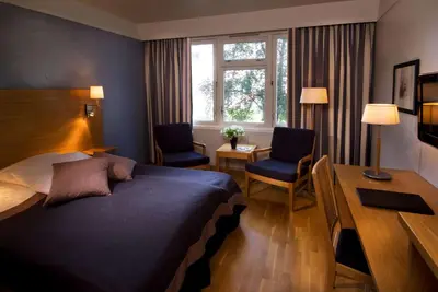 a hotel room with a bed and a desk and a desk at Scandic Sunnfjord Hotel & Spa in Førde