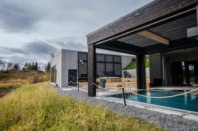 an external view of a house with a swimming pool at Røros Hotell - Bad & Velvære in Røros
