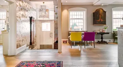 a living room with colorful chairs and a table at Hotel Park Bergen in Bergen