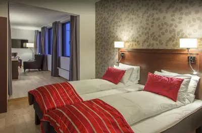 a hotel room with two beds with red pillows at Thon Hotel Victoria Hamar in Hamar