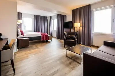a hotel room with a bed and a chair at Thon Hotel Victoria Hamar in Hamar