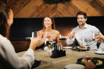 a group of people sitting around a table with wine glasses at Vestlia Resort in Geilo