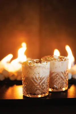 two glasses of water with candles in a fireplace at Vestlia Resort in Geilo