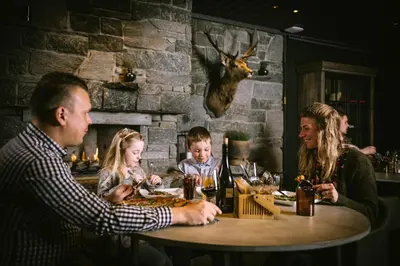 a group of people sitting at a table in a restaurant at Highland Lodge in Geilo