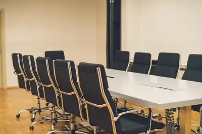 a conference room with a white table and chairs at Dombås Hotel in Dombås