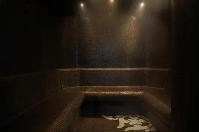 a dark bathroom with a bath tub in a room at Quality Hotel Strand Gjøvik in Gjøvik