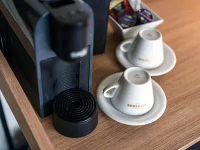 a coffee maker with two cups on a table at Quality Hotel Strand Gjøvik in Gjøvik