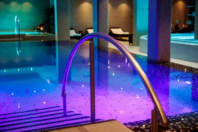 a swimming pool with a purple ramp leading to a swimming pool at Quality Hotel Strand Gjøvik in Gjøvik
