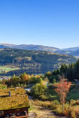 a view of a valley with a building with a grass roof at Voss Resort self-service apartments in Skulestadmo