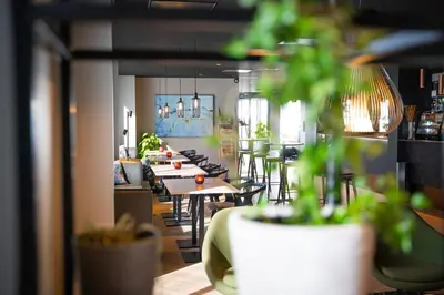 a row of tables and chairs in a restaurant at Scandic Victoria Florø in Florø