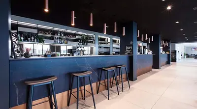 a blue bar with stools in a restaurant at Scandic Victoria Florø in Florø