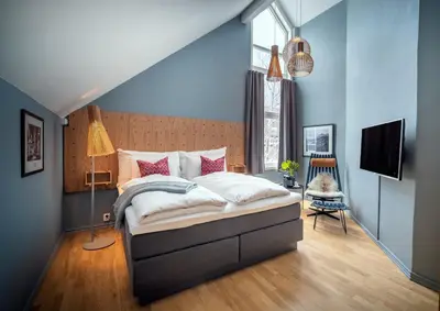 a bedroom with a bed and a blue wall at Molde Fjordhotell - by Classic Norway Hotels in Molde