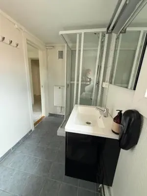a bathroom with a sink and a mirror at Grand Hotel Hønefoss in Hønefoss