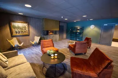 a living room with a couch and chairs and a table at Trysil-Knut Hotel in Trysil
