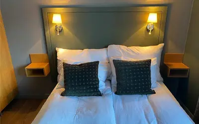 a bedroom with a bed with two pillows at Trysil-Knut Hotel in Trysil