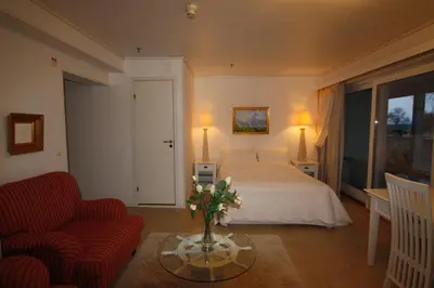 a hotel room with a bed and a table with flowers at Sunde Fjord Hotel, free and easy parking in Solavagen