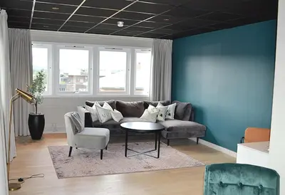 a living room with a couch and a table at Thon Hotel Central in Elverum