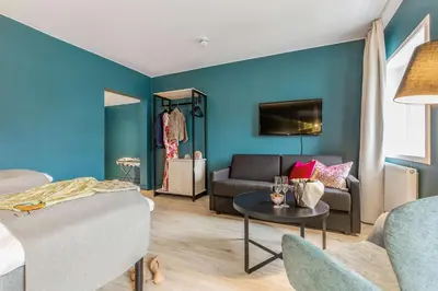 a living room with a couch and a table at Thon Hotel Central in Elverum