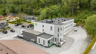 an aerial view of a large white building at Kinn Hotell Florø in Florø