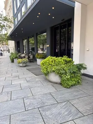 a building with potted plants in front of a building at Zander K Hotel in Bergen