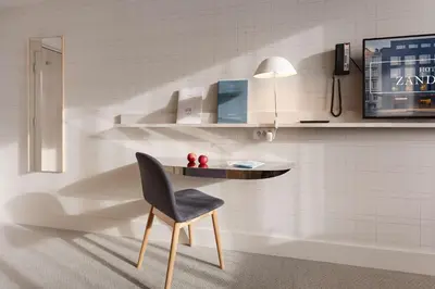a table and a chair in a room at Zander K Hotel in Bergen