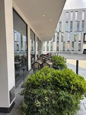 a row of benches in a building with plants at Zander K Hotel in Bergen