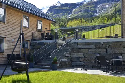 a patio with stairs and a table and chairs at Aga Fjord Apartments Hardanger in Nå