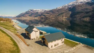 an aerial view of a building on a body of water at Aga Fjord Apartments Hardanger in Nå