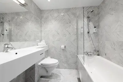 a bathroom with a toilet and a sink and a shower at Scandic Parken in Ålesund