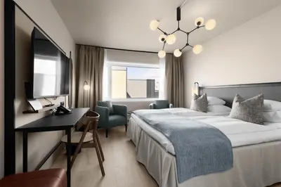 a hotel room with a bed and a desk at Scandic Parken in Ålesund