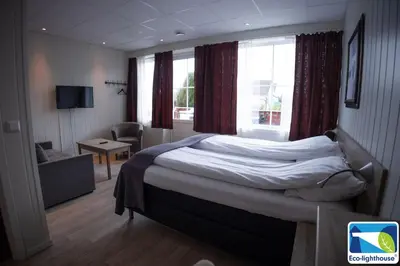 a hotel room with a bed and a window at Askvoll Fjordhotell in Ask