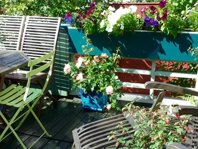 a patio with a table and a vase of flowers at Annehelenes B&B in Bergen
