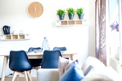 a living room with a table and chairs at Tynset Hotel in Tynset