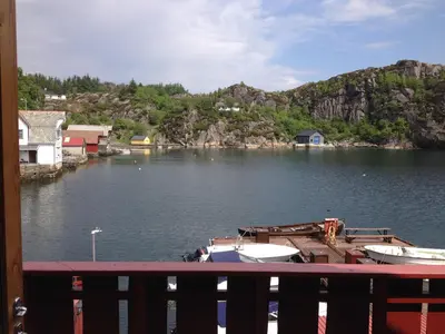 a view of a river with boats in the water at Sotra Rorbusenter in Kåravika