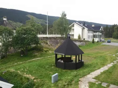a dog in a gazebo in a yard at Fosheim Hytter in Ron