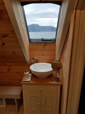 a bathroom with a sink and a window at Nicoll-huset in Ølve