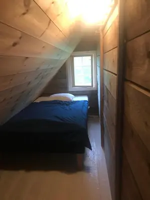 a bedroom with a bed and a window in it at Nicoll-huset in Ølve