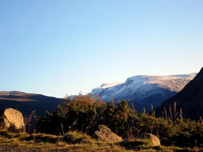a view of a mountain range with rocks and trees at Strind Gard, Visdalssetra in Boverdalen