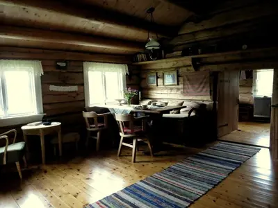 a room with a table and chairs in a cabin at Strind Gard, Visdalssetra in Boverdalen
