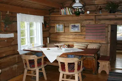 a dining room with a table and chairs in a cabin at Strind Gard, Visdalssetra in Boverdalen