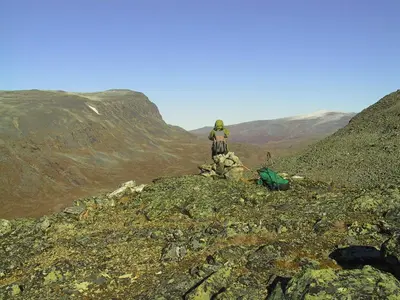 a person standing on the top of a mountain at Strind Gard, Visdalssetra in Boverdalen