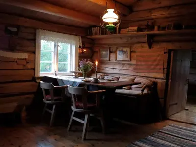 a dining room with a table and chairs in a cabin at Strind Gard, Visdalssetra in Boverdalen