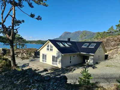 a house with solar panels on top of it at Ropeid Villa Fjordferie in Ropeid