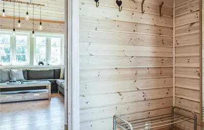 a living room with a wooden wall at Tokagjelet in Norheimsund