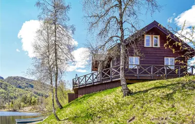a house on a hill next to a lake at Tokagjelet in Norheimsund