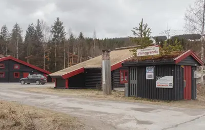 a building with a car parked in a parking lot at Gorgeous Apartment In Trysil With Sauna in Trysil