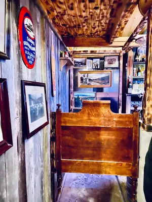 a wooden bed in a room with pictures on the wall at Hesla Farm in Gol
