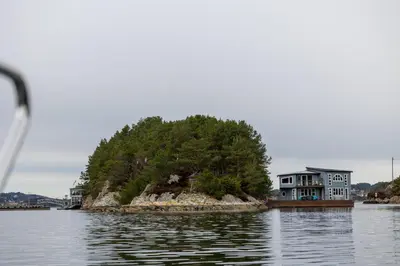 a house on an island in the water at Floating Villa Bergen in Bergen